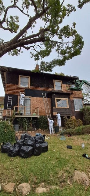 people working on house siding